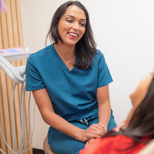 Woman smiling outdoors after cosmetic dentistry in Mansfield