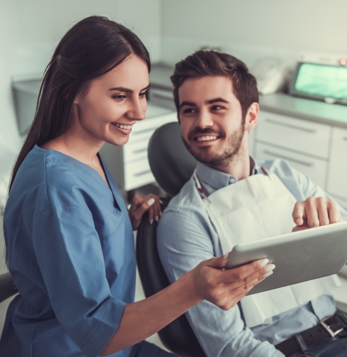 Dental team member showing a tablet to a patient