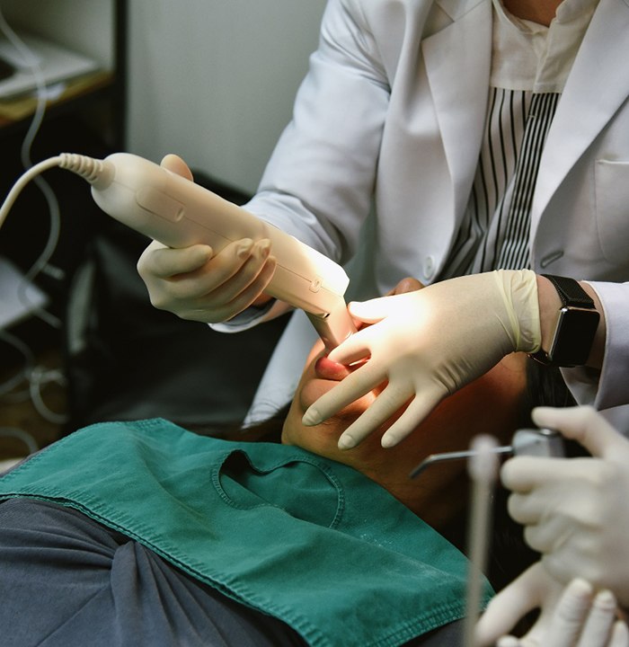 a dentist taking a digital impression of a tooth