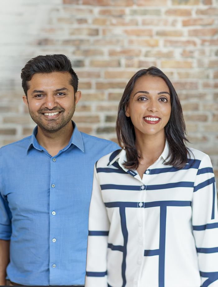 Mansfield Texas dentists Doctor Rushabh Doshi and Rini Bavishi smiling with their baby