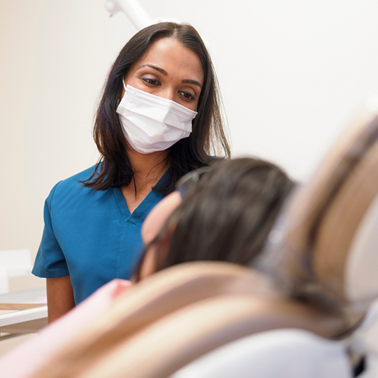 Woman holding her cheek in pain before emergency dentistry in Mansfield