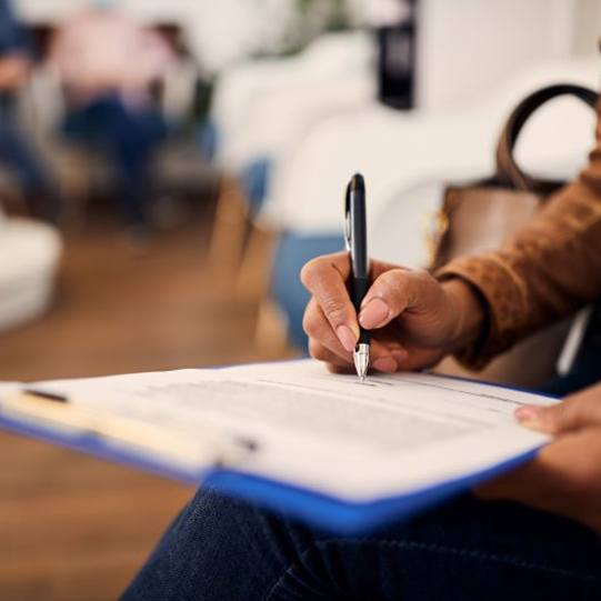 Woman filling out insurance form in dental office