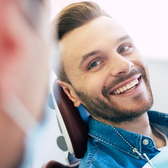 Man smiling at Mansfield dental team member