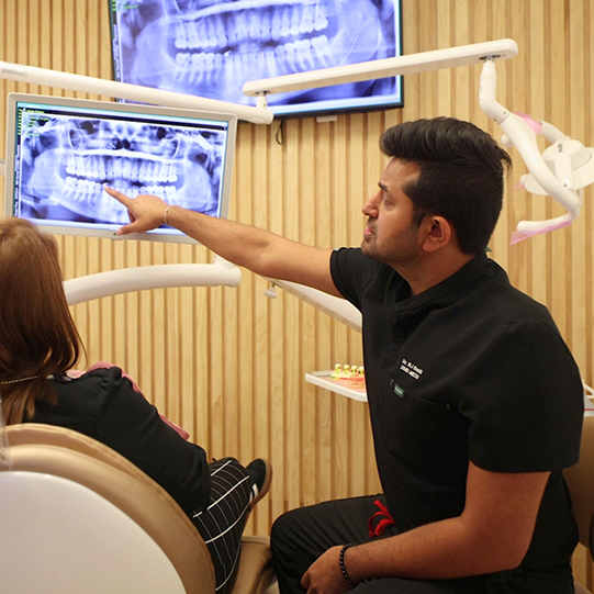 Man sitting on couch smiling after preventive dentistry visit