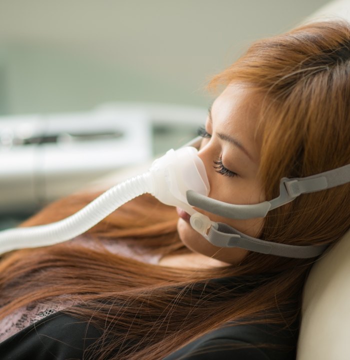 Sleeping woman with C P A P mask on her face